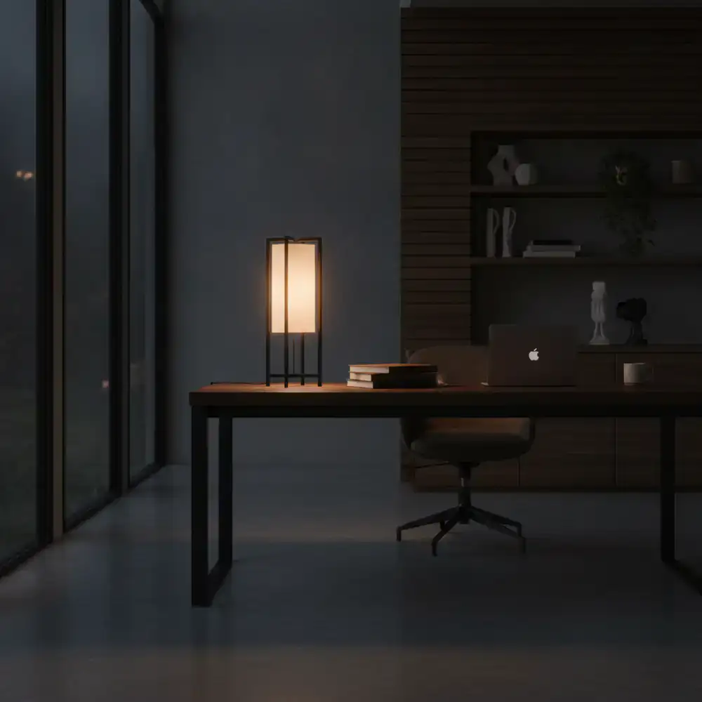 Sleek matte black minimalist lamp on a bedside table