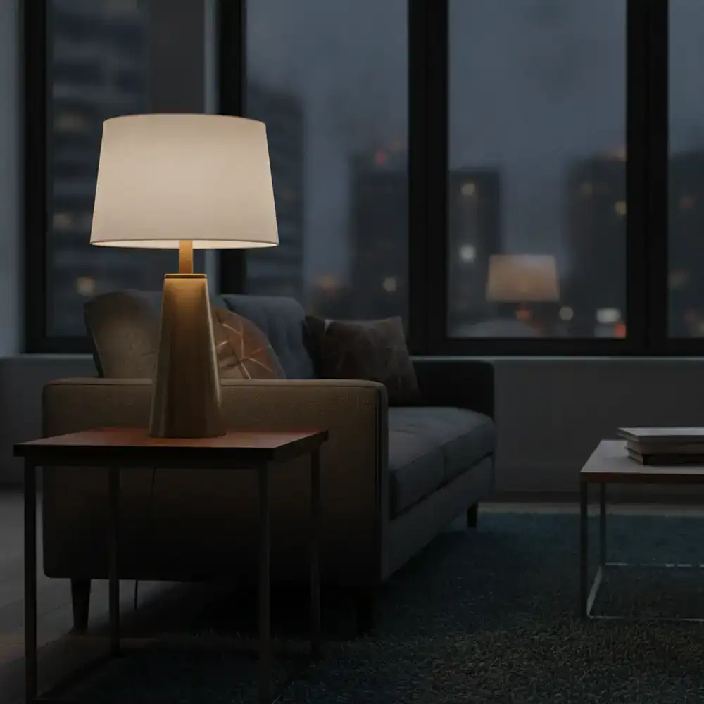Elegant table lamp casting a soft warm light over a contemporary living room sofa setup